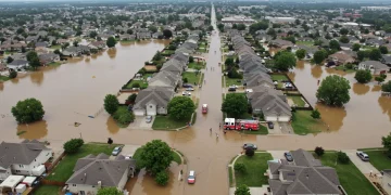 Suburban neighborhood flooded after heavy rainfall, emergency response